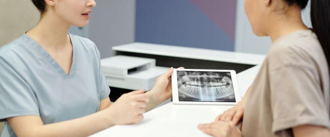 Picture of technicians looking at a dental x-ray