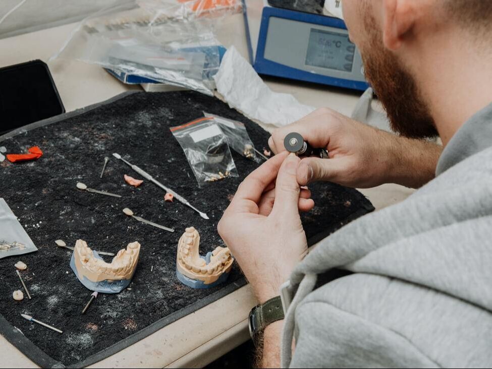 Picture of a technician working on teeth.